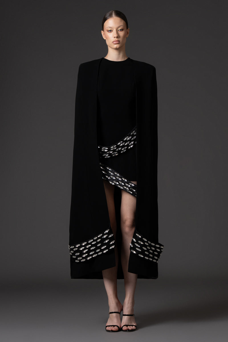 Embroidered short black crêpe dress paired with a cape