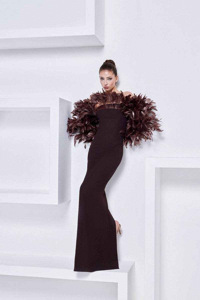 A crêpe gown with voluminous feathers on neckline and sleeves