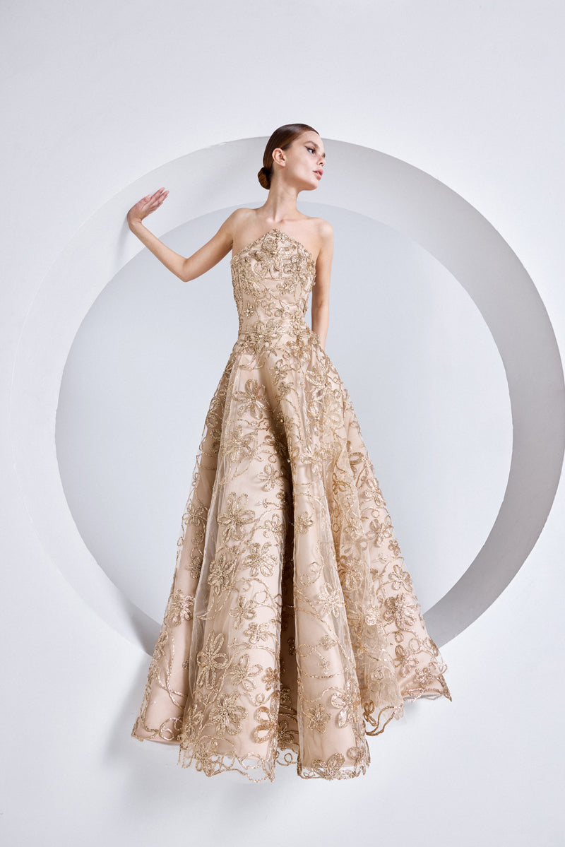 A strapless raffia-embroidered A-line gown with crystal stones on the  bodice