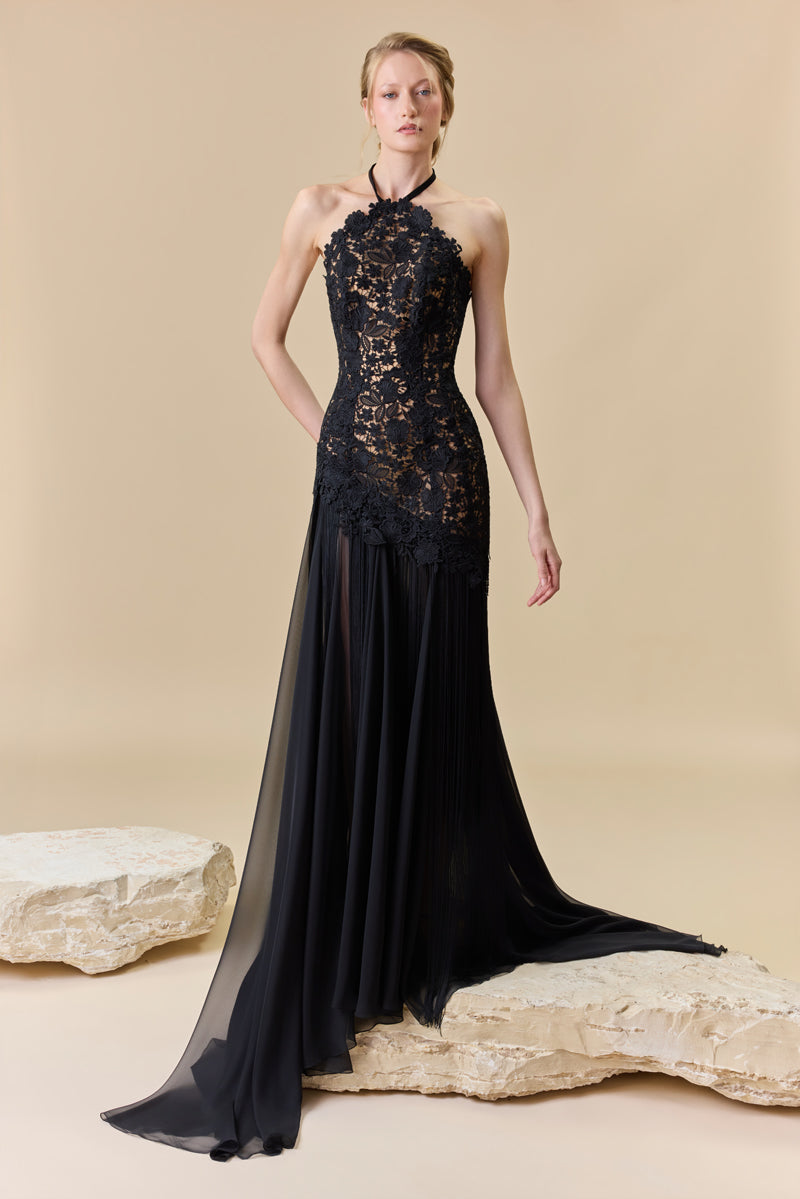 A guipure halter-neck gown with a fitted bodice and a chiffon skirt with silk fringes on it.