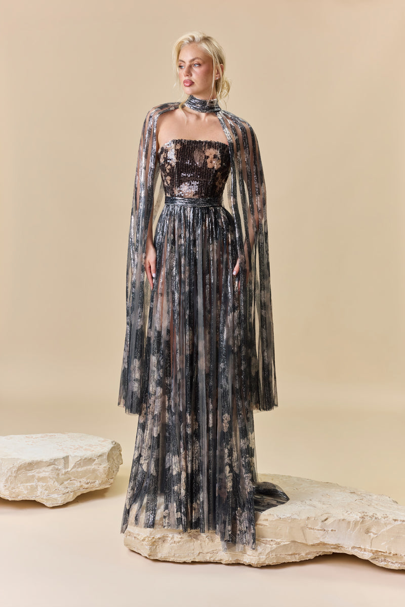 A strapless printed sequins A-line dress with a flowing cape.