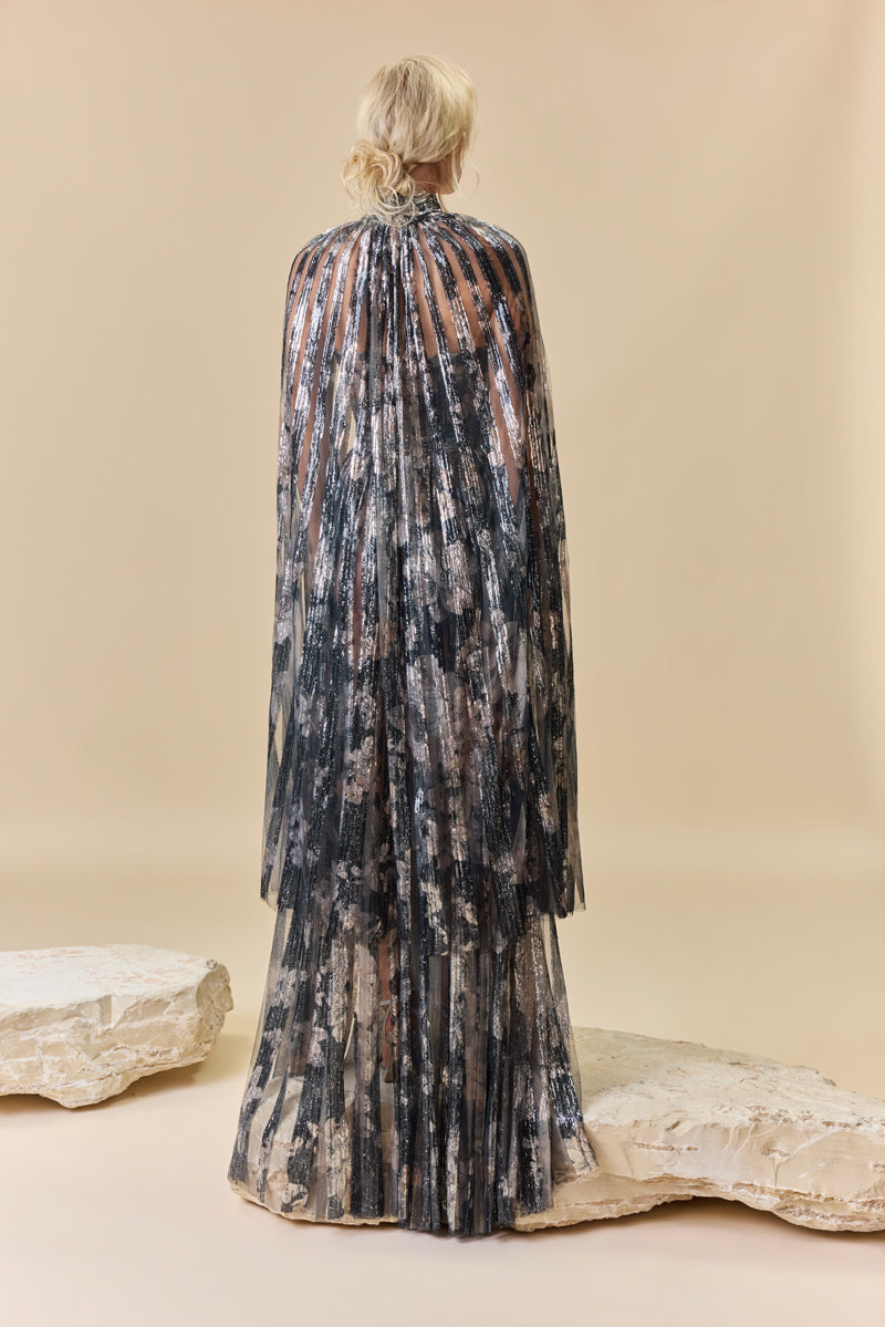 A strapless printed sequins A-line dress with a flowing cape.