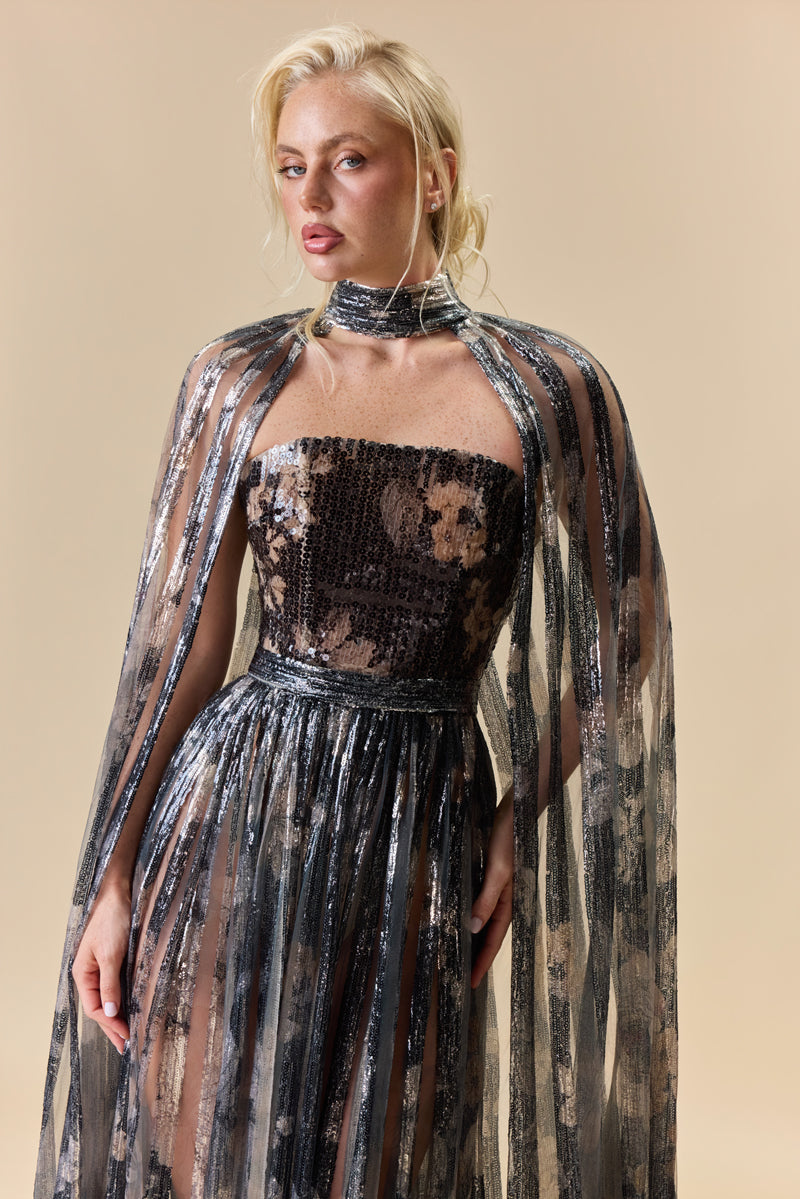A strapless printed sequins A-line dress with a flowing cape.
