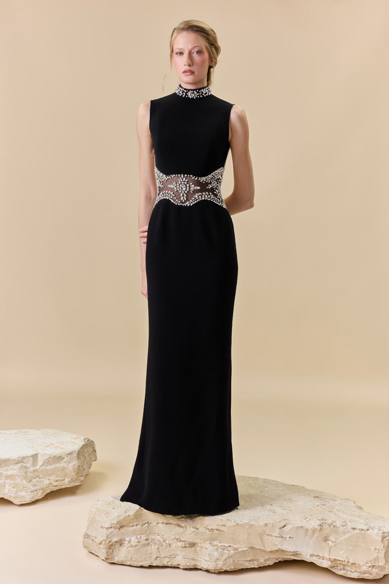 A crêpe fitted dress with an open back, a train at the back, and crystal detailing along the neckline, waist, and back borders.