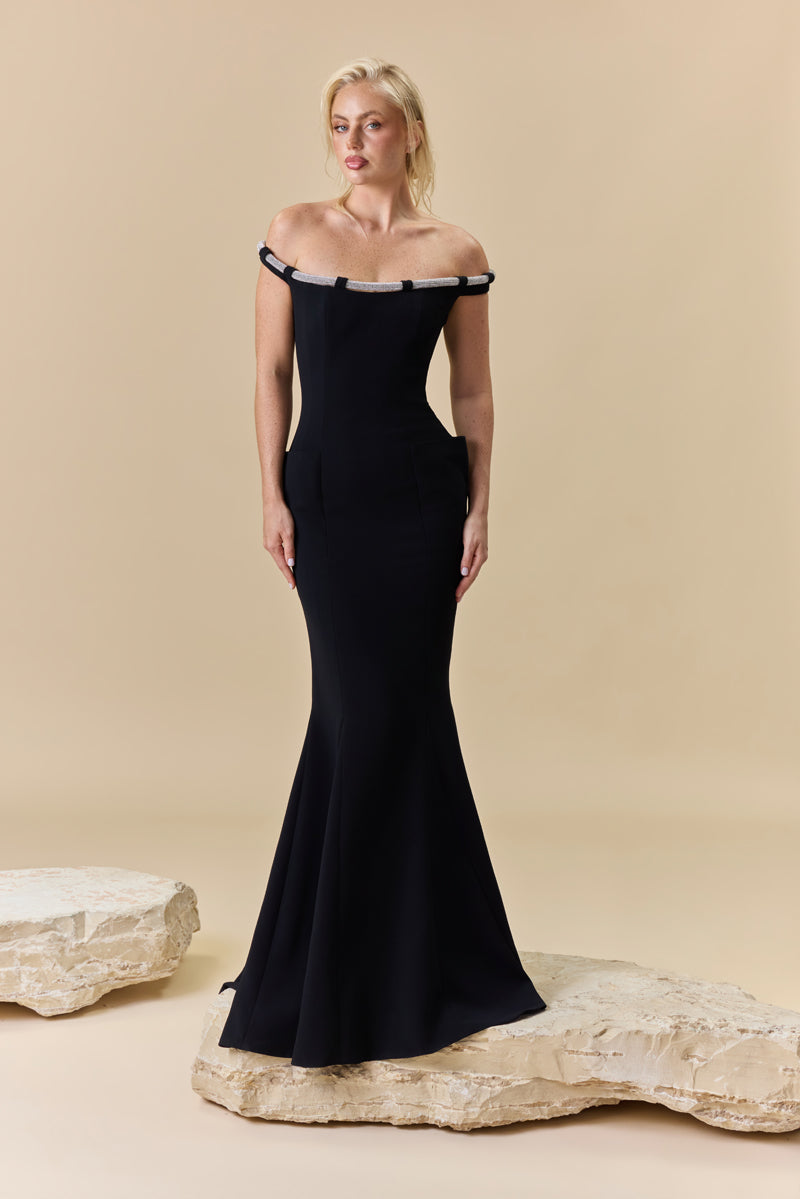 An off-shoulder crêpe fitted dress with pockets and a beaded chord detail along the neckline.