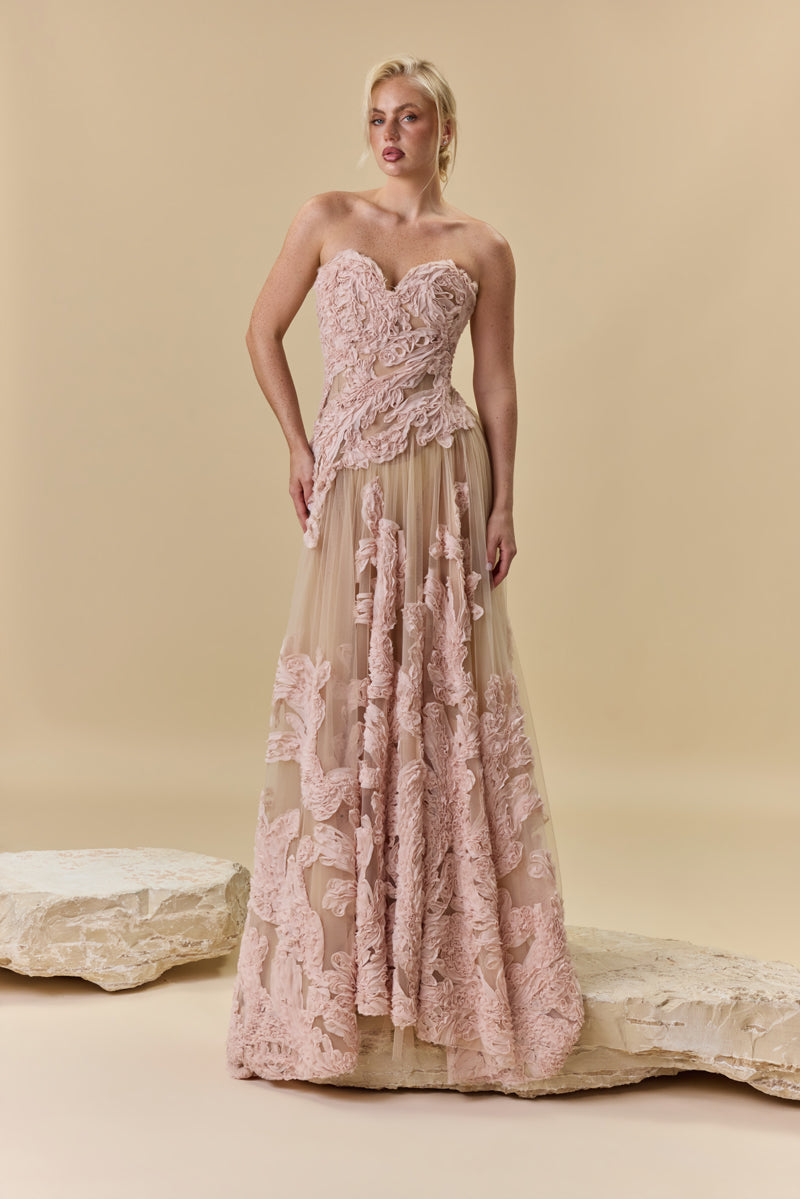 A strapless sculpted strapless corset embellished with intricate crepe georgette trims flowing into a sheer gathered tulle skirt.