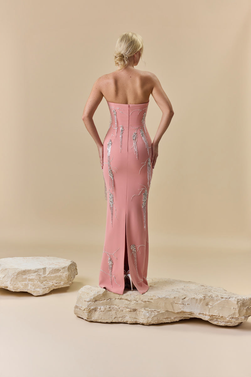A fitted strapless crêpe gown with pointed waist, detailed with crystals and beads embellishments.