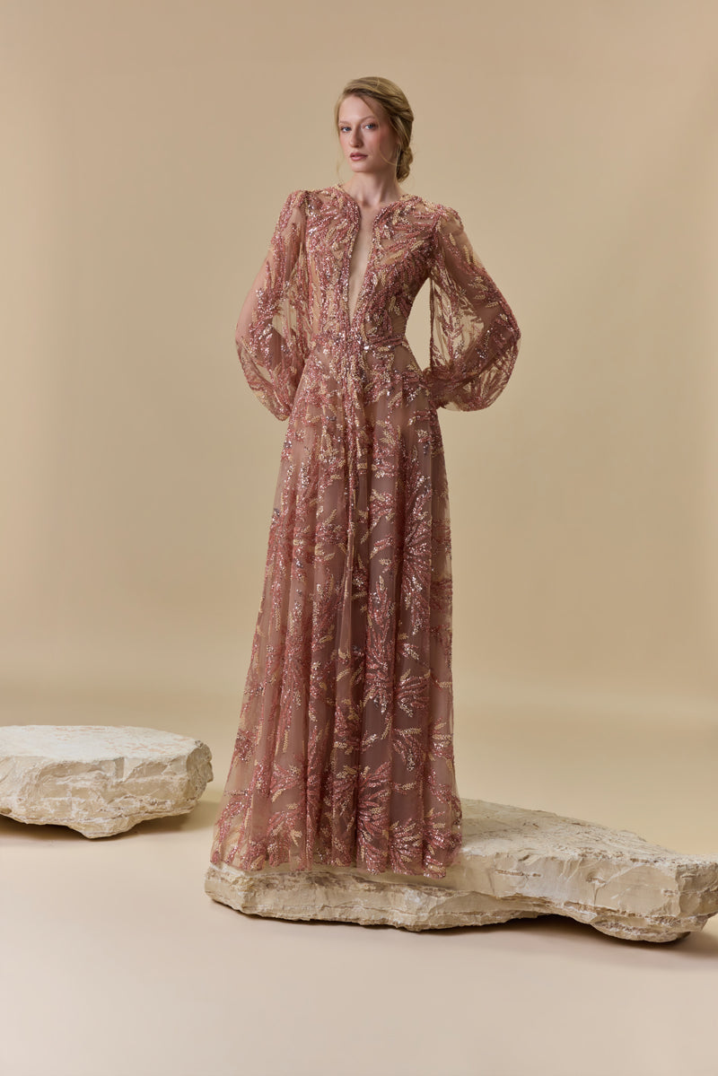 A fully embroidered tulle dress with puffed sleeves and a front slit.