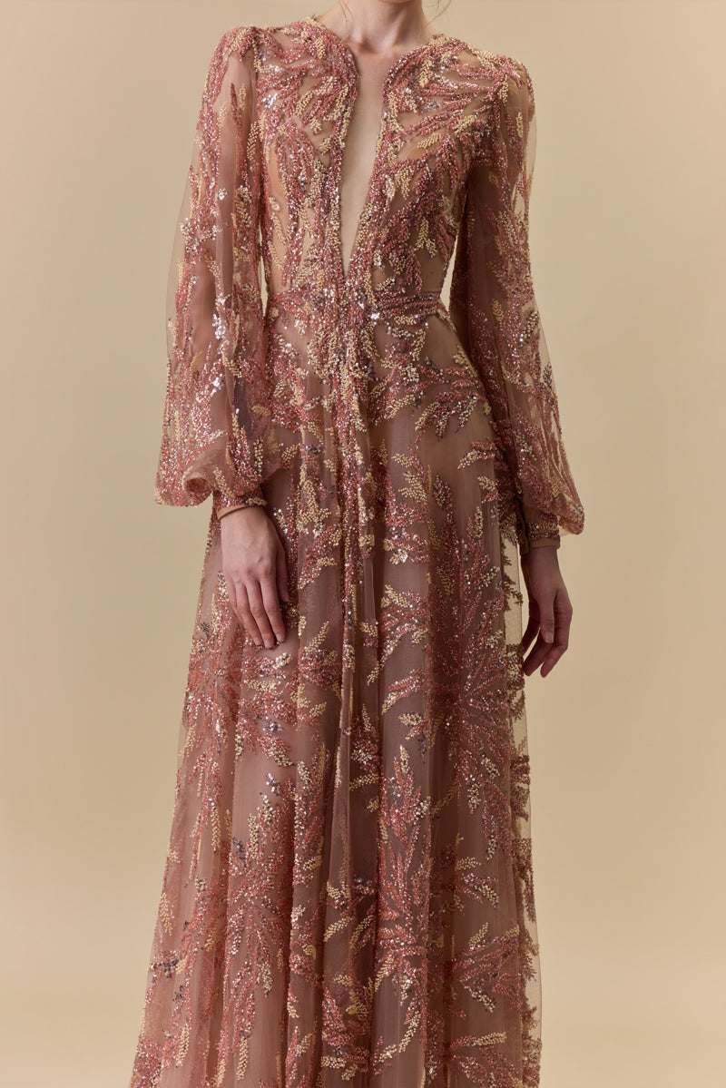 A fully embroidered tulle dress with puffed sleeves and a front slit.