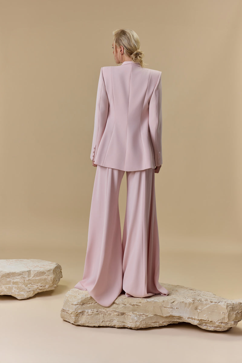 A strapless crêpe jumpsuit with an embroidered tulle corset embellished with crystals and stones, paired with a matching crêpe jacket.