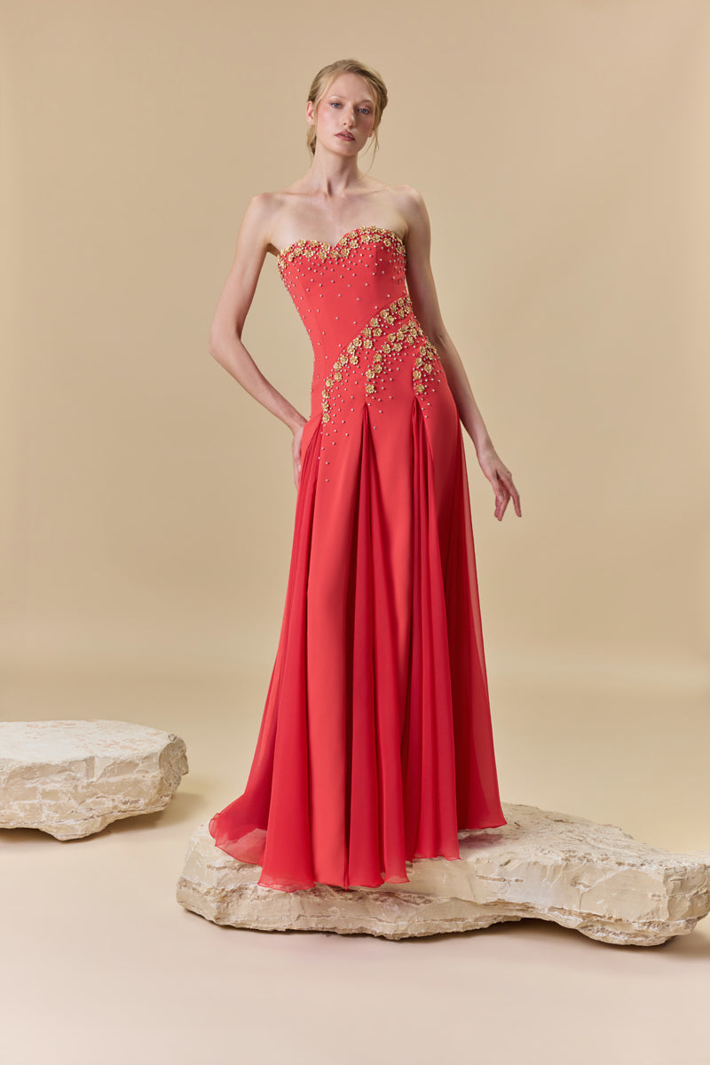 A strapless crêpe dress with A-line chiffon godet panels , embellished with metallic flowers and crystals.