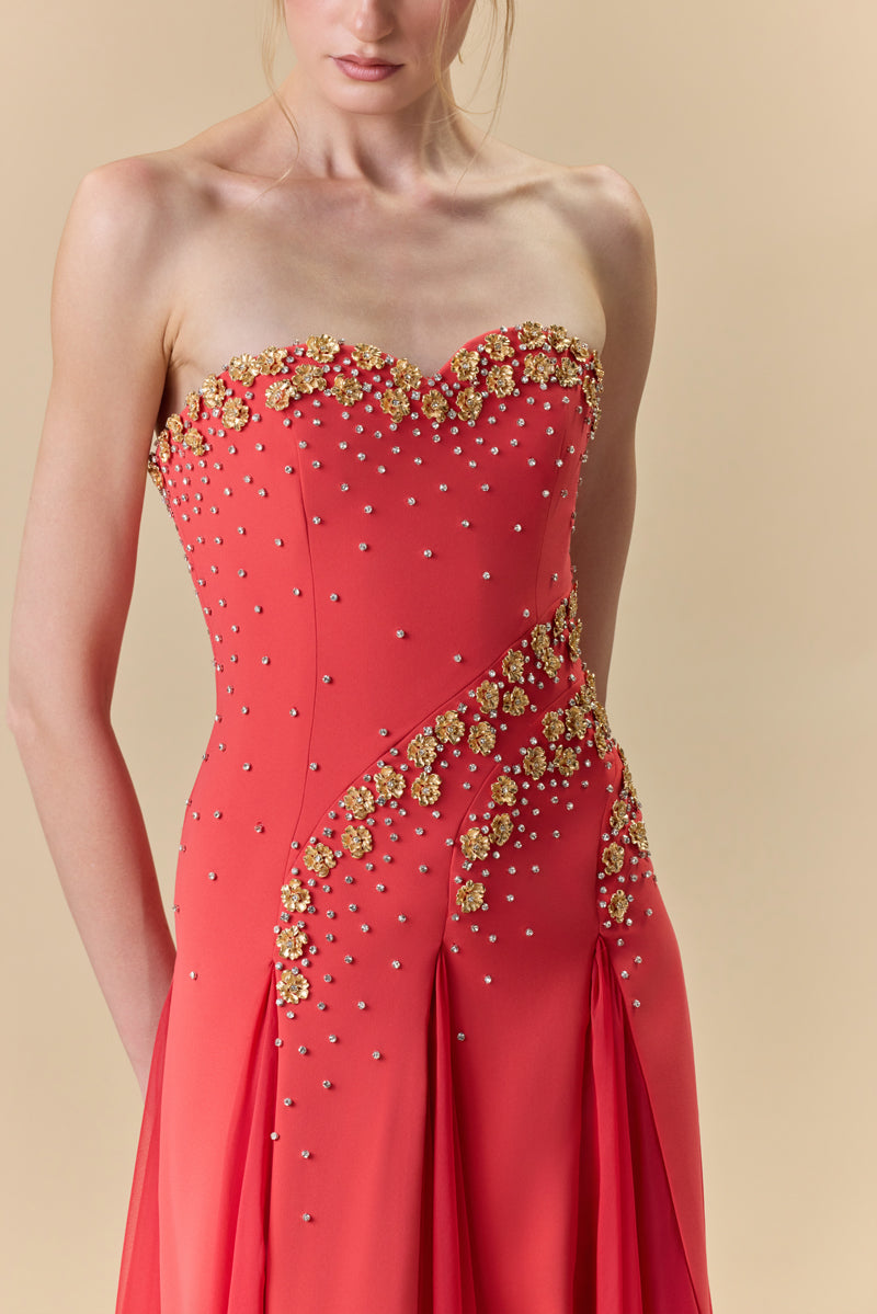A strapless crêpe dress with A-line chiffon godet panels , embellished with metallic flowers and crystals.