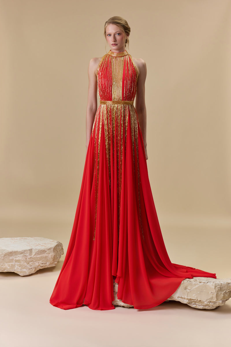 A halter neck dress featuring a crepe bodice and an A-line chiffon skirt with beaded fringes on it.