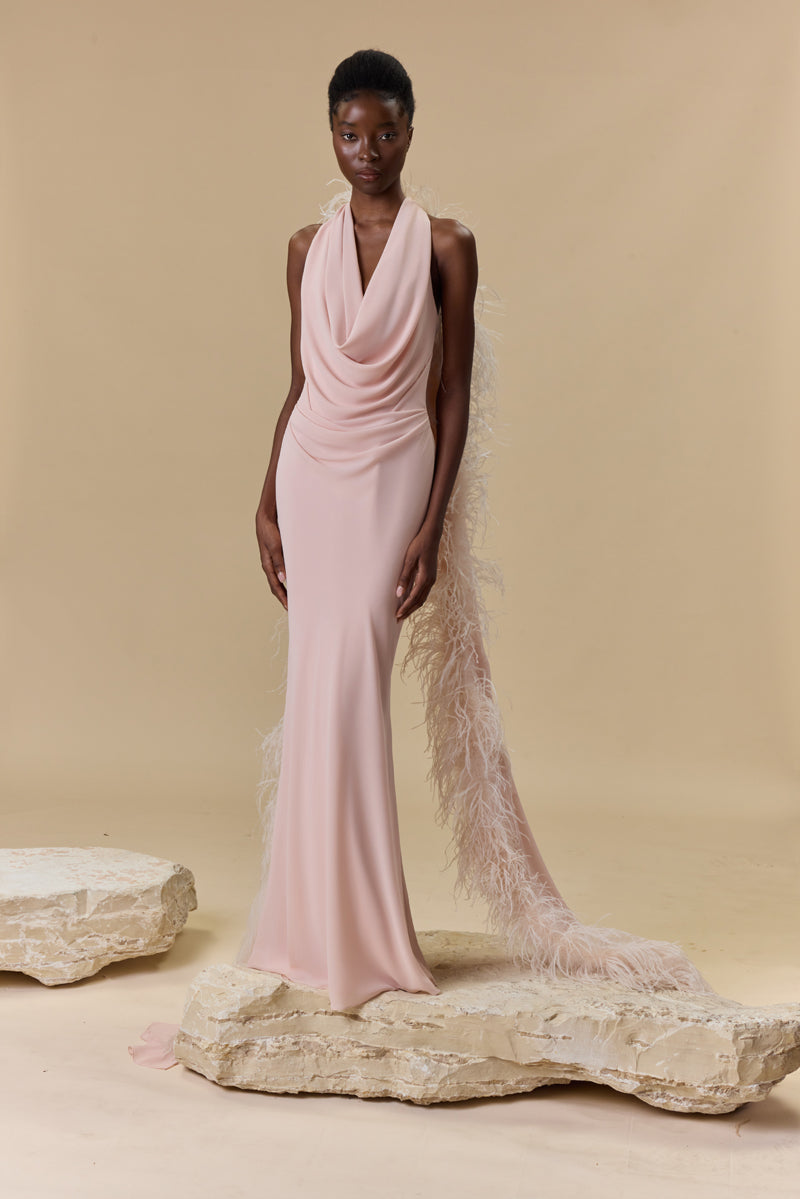 A georgette draped halter-neck dress a trimmed feather cape.