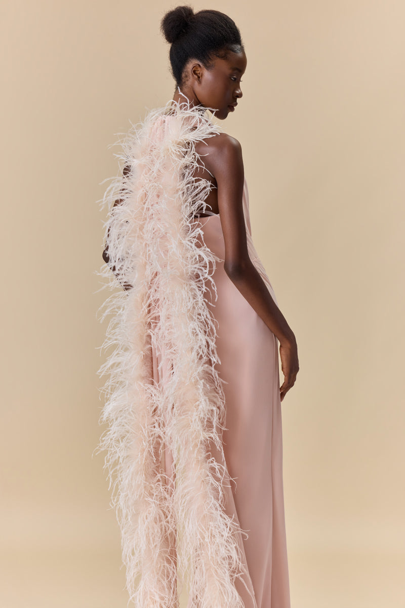 A georgette draped halter-neck dress a trimmed feather cape.