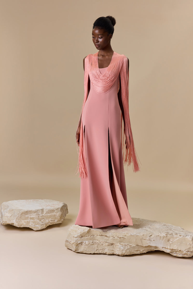 A crepe straight dress with silk fringes on sleeves and neckline with a high front slit.