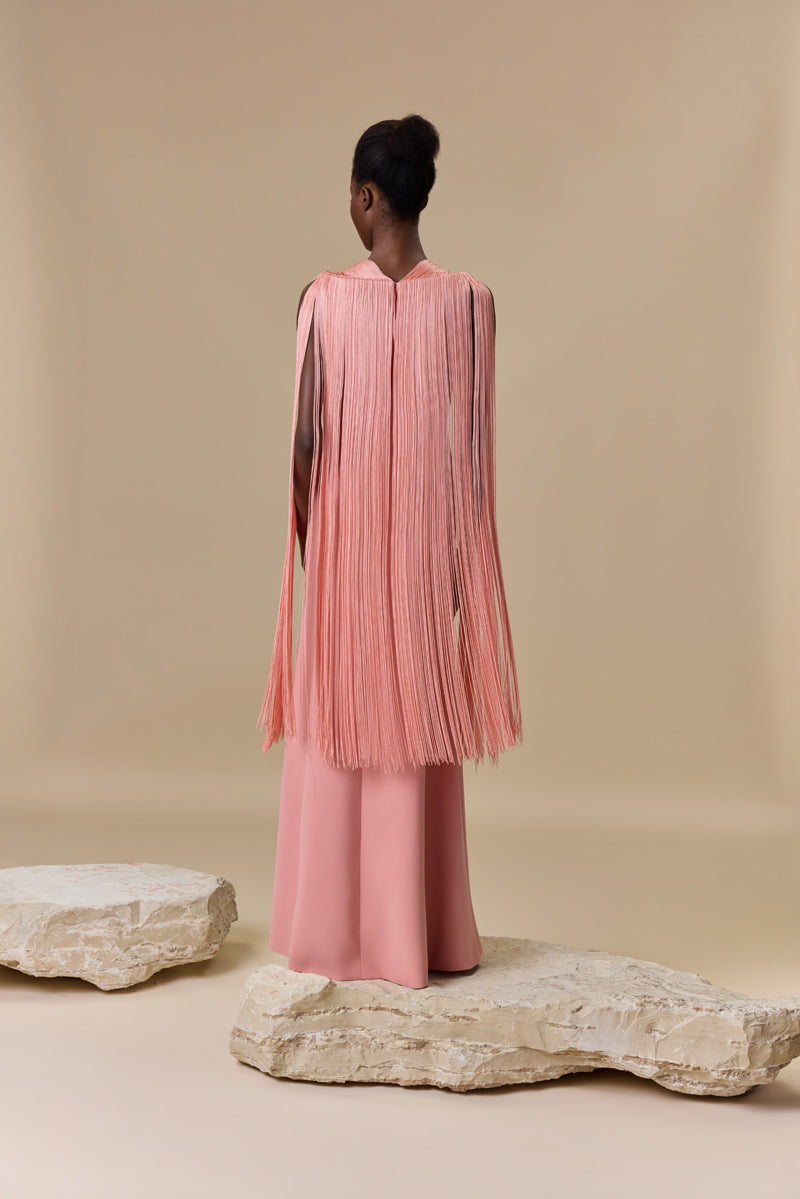 A crepe straight dress with silk fringes on sleeves and neckline with a high front slit.