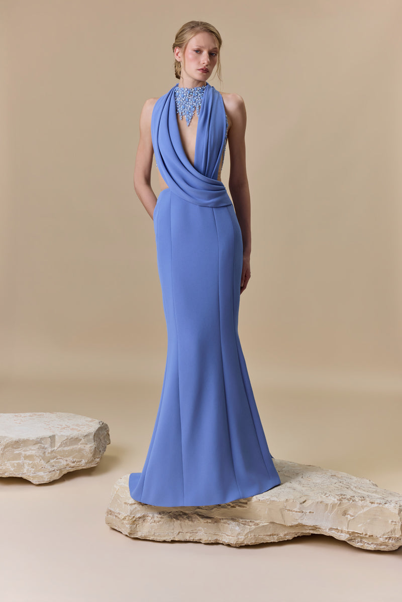 A fitted straight crêpe dress embellished with shimmering accents of crystals and beadings, designed with a plunging neckline and an open back.