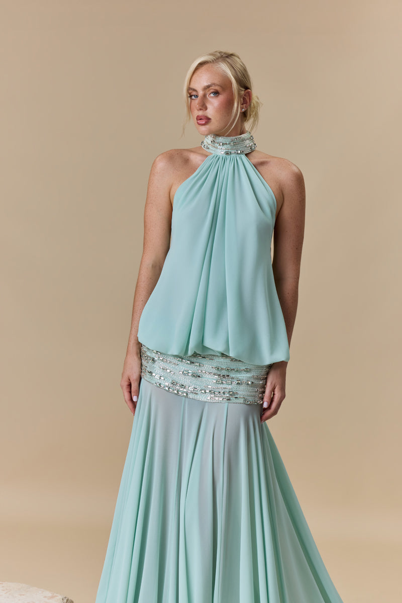 A georgette dress featuring a high neckline, a blouson effect halter bodice, and a flowing A-line skirt, with crystal embellishment along the neckline and waist.