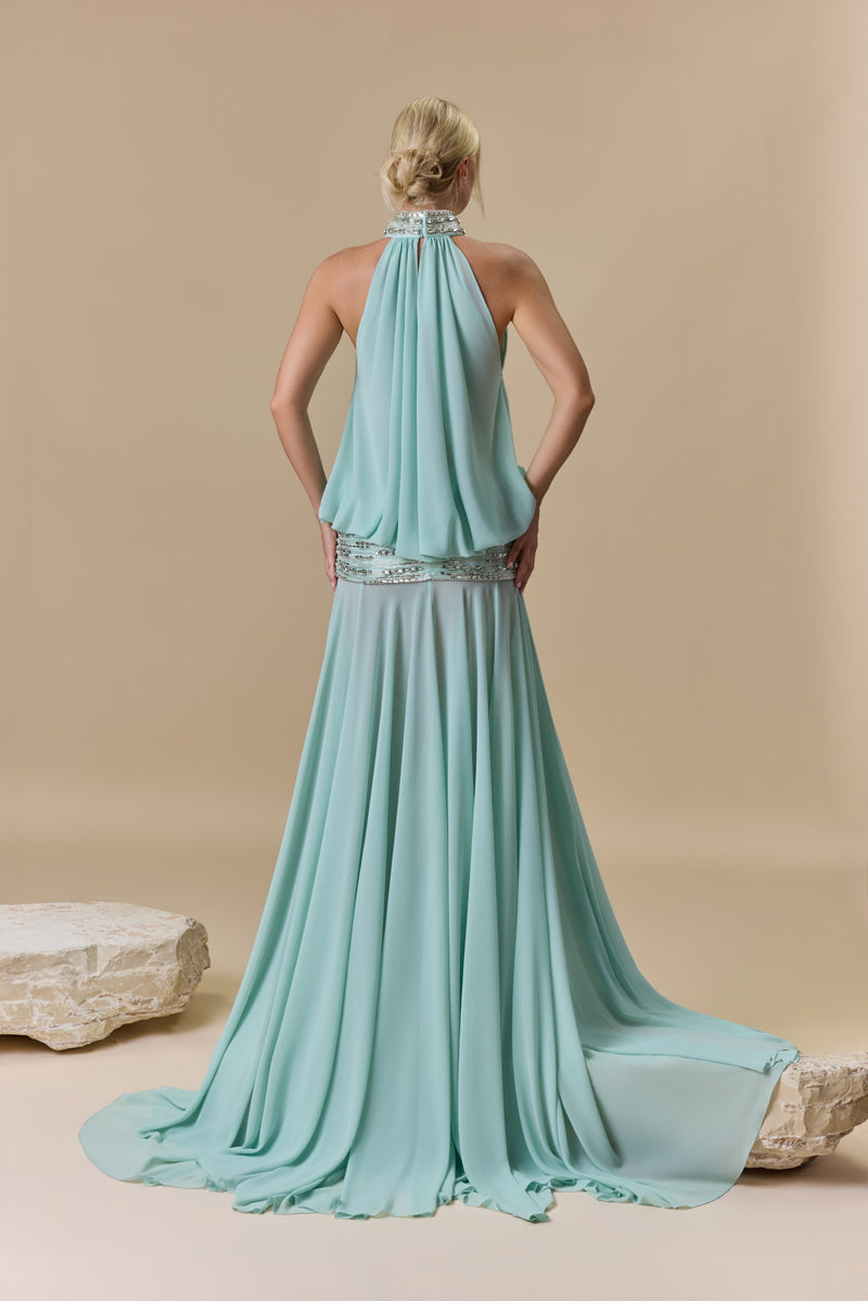 A georgette dress featuring a high neckline, a blouson effect halter bodice, and a flowing A-line skirt, with crystal embellishment along the neckline and waist.