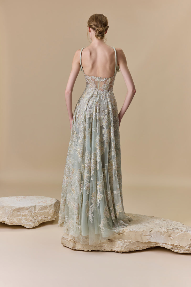An embroidered tulle A-line dress with 3D flowers on the bust and halter beaded cords on the neck.