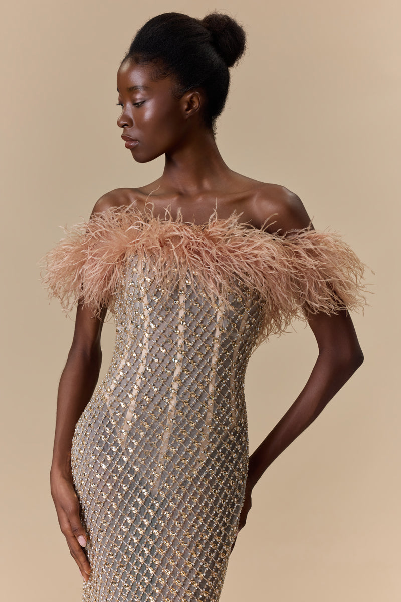 A strapless fitted dress fully beaded with crystals and finished with an off-shoulder feather trimmed neckline.