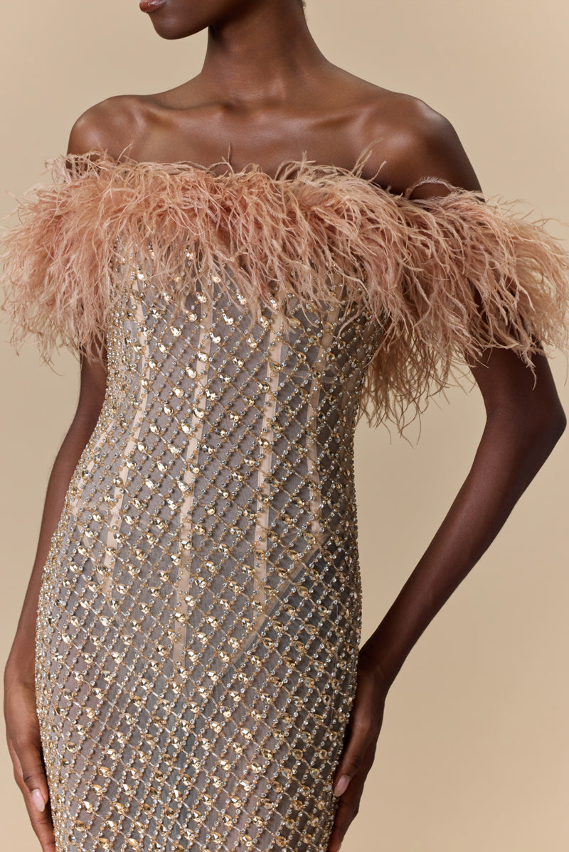 A strapless fitted dress fully beaded with crystals and finished with an off-shoulder feather trimmed neckline.