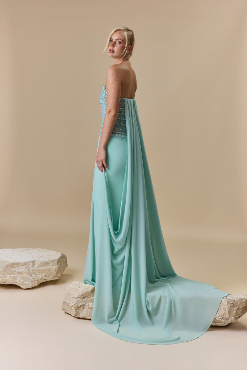 A strapless dress featuring a crystal-embellished corset bodice and a draped georgette skirt with a flowing back train.