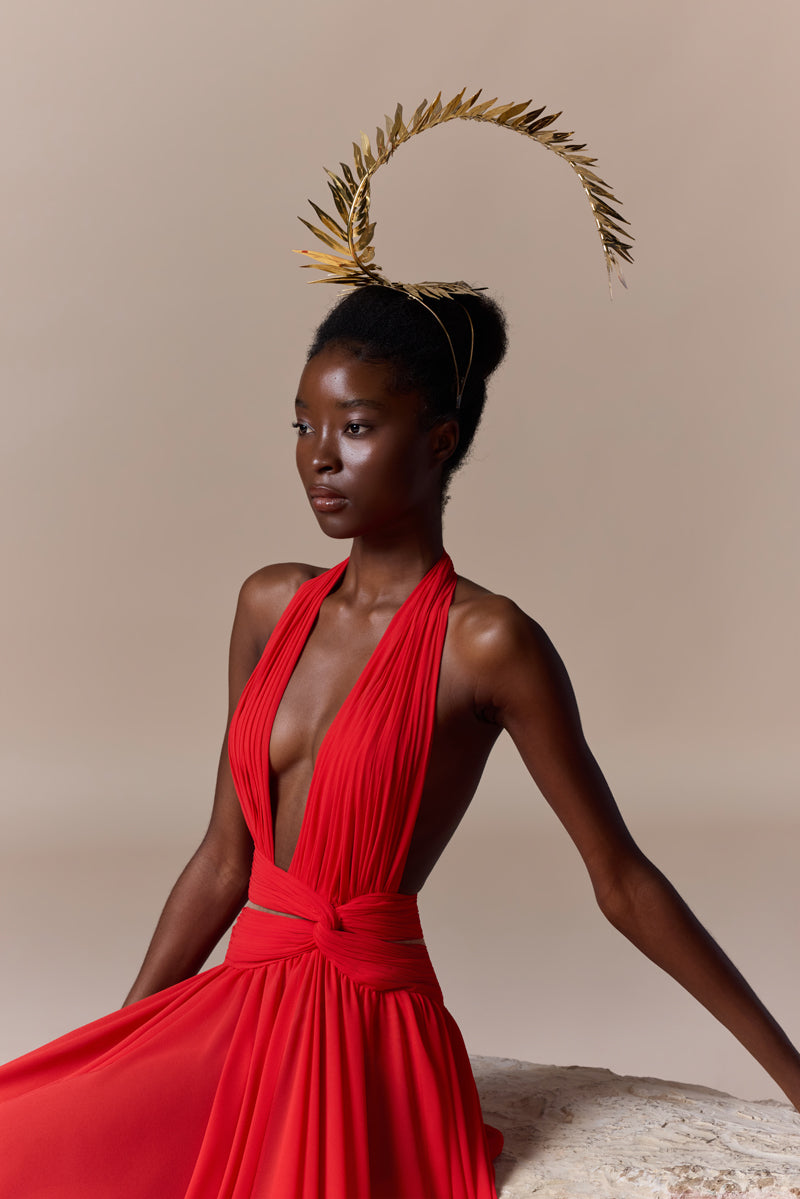 A flowing deep V georgette dress with a knot detail at the waist and a high slit.