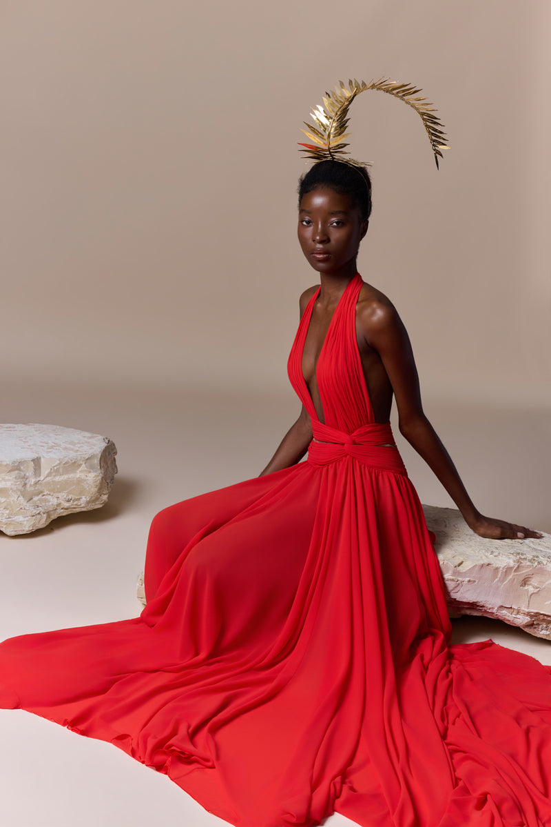 A flowing deep V georgette dress with a knot detail at the waist and a high slit.