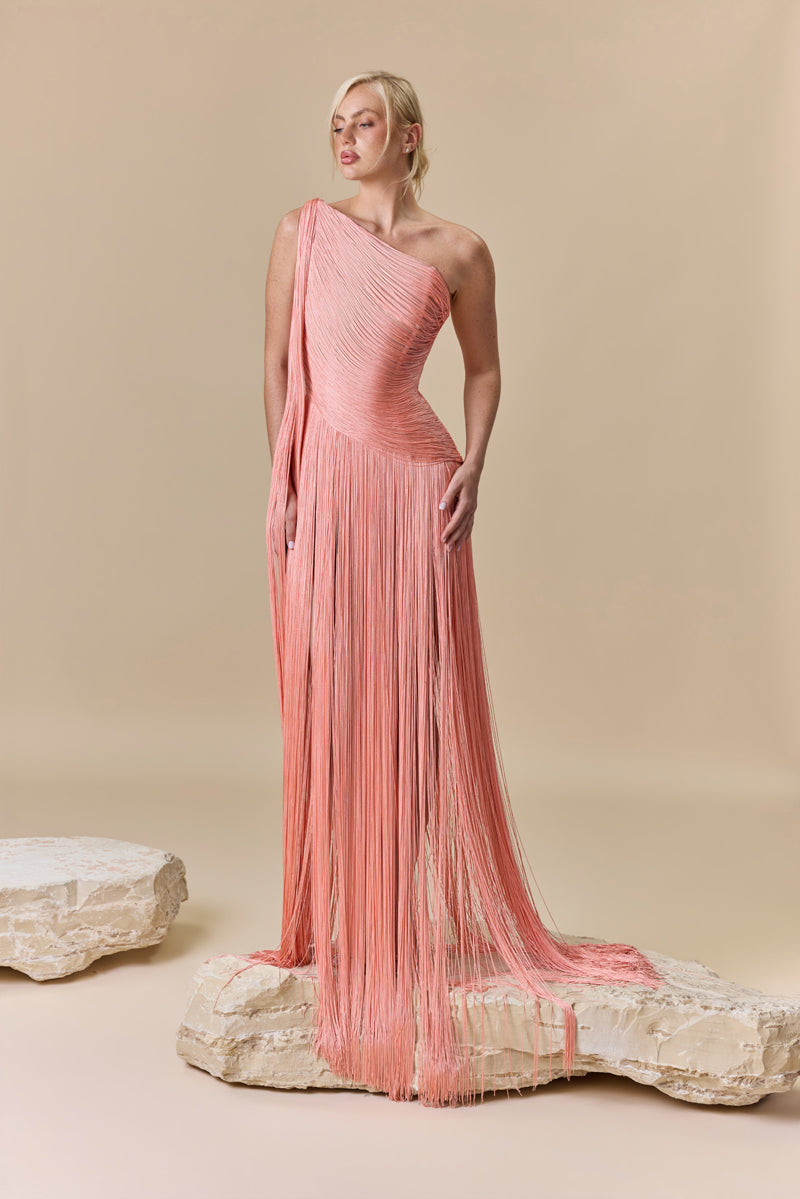 An asymmetrical one-shoulder dress made with silk fringes.