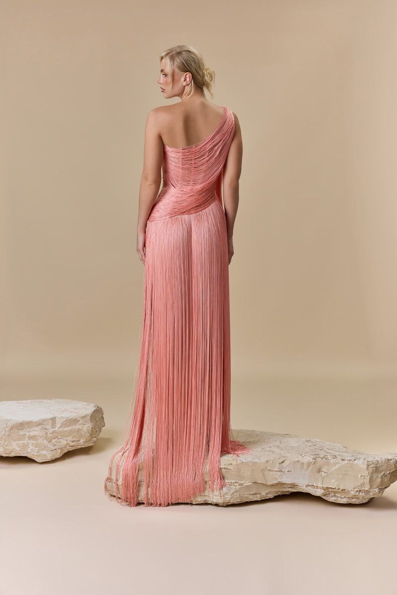 An asymmetrical one-shoulder dress made with silk fringes.