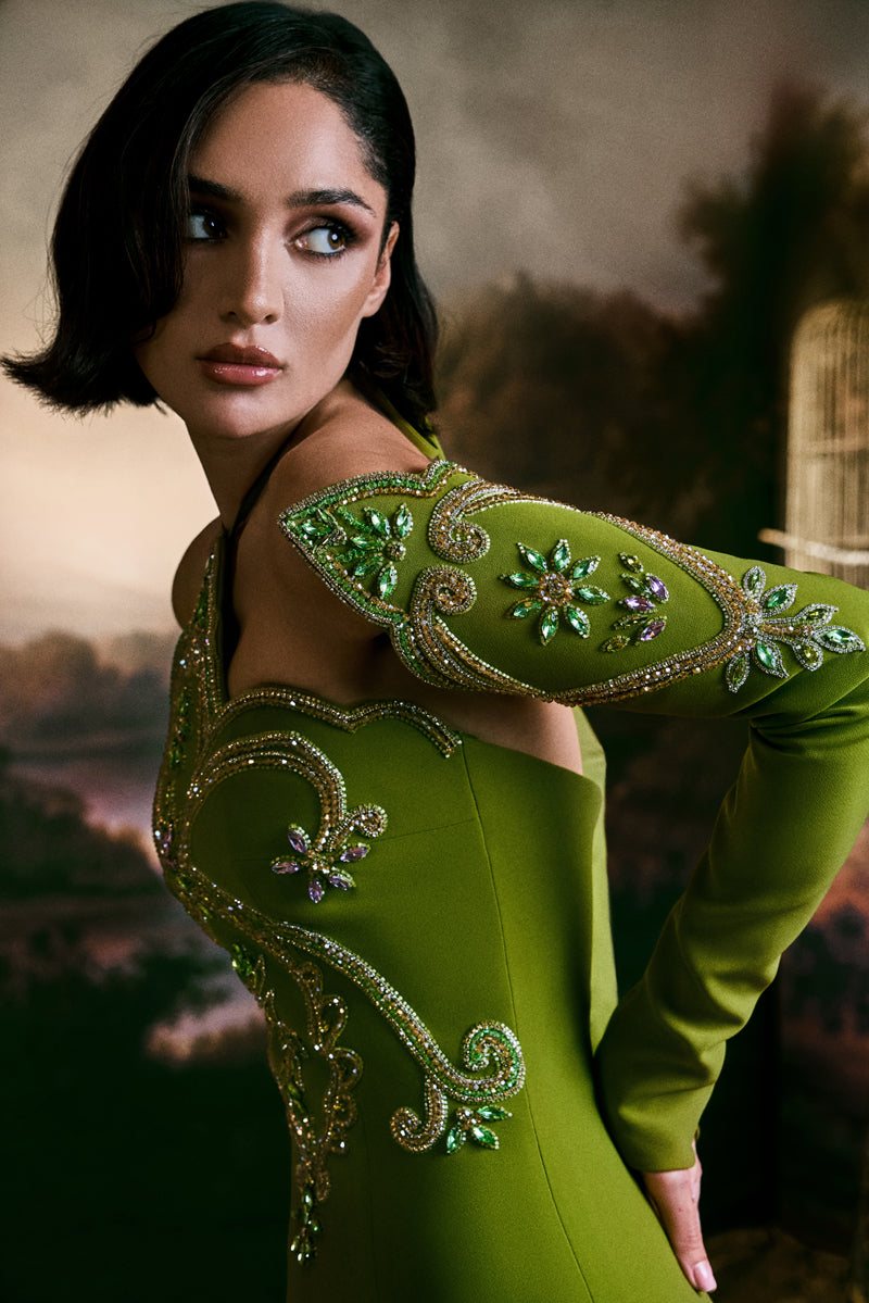 Fitted gown featuring a pointed neckline and matching sleeves