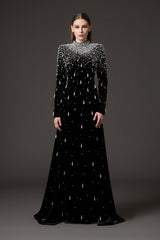 Black velvet dress with crystal and pearl embroidery paired with an overskirt‭