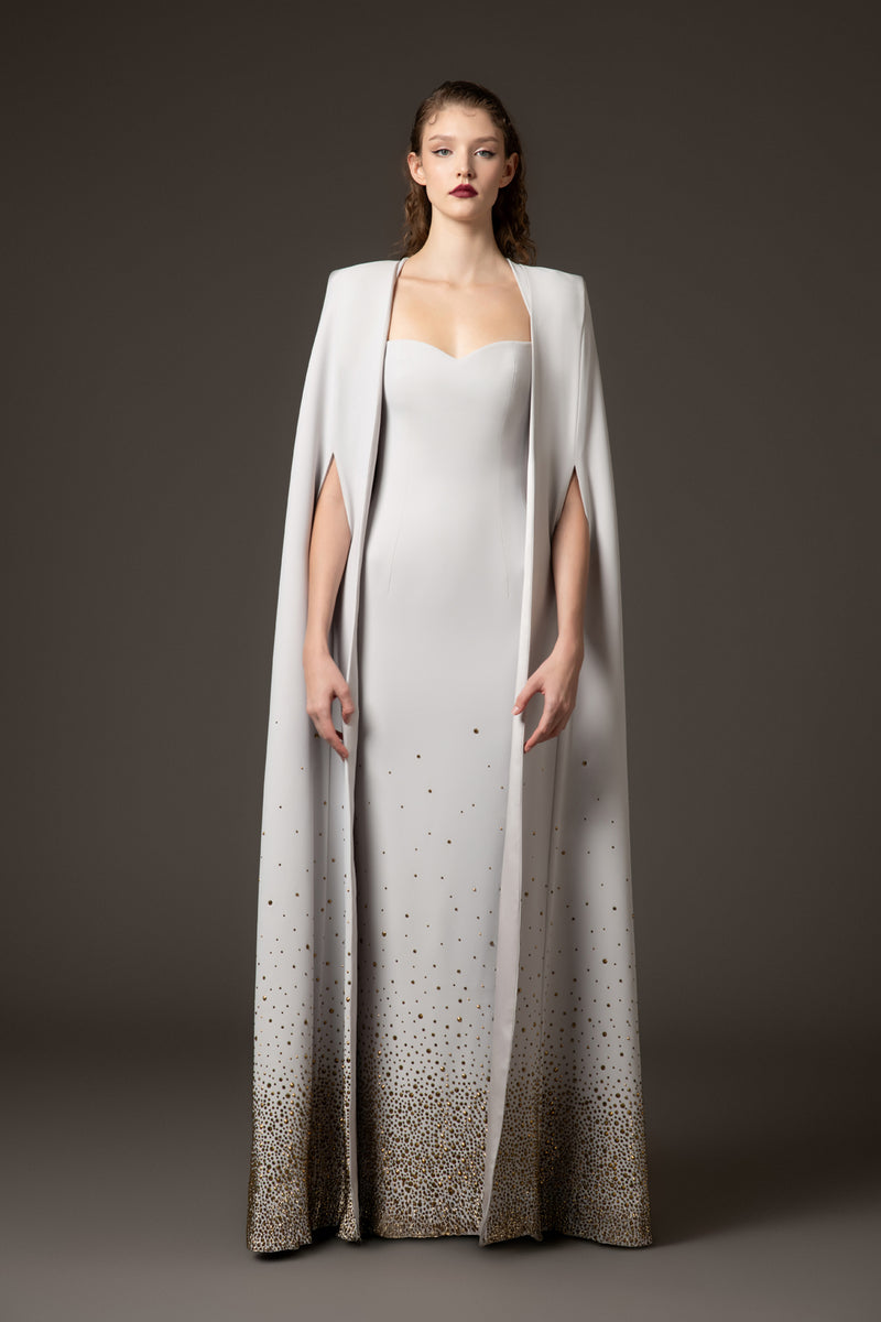 Embroidered light grey crêpe dress paired with a cape