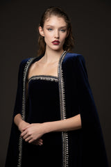 Embroidered velvet blue dress paired with a cape‭