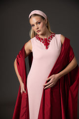 Pink crêpe abaya paired with a red taffeta cape