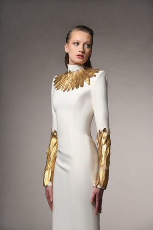 Ivory white dress with gold feathers on the neckline and sleeves