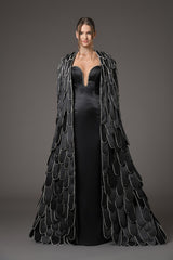 Black scuba dress with a cape with an overflow of layered hand-crafted plumes in scuba and crystals