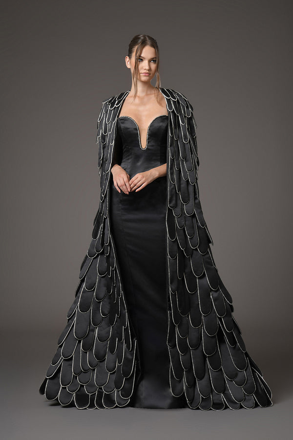 Black scuba dress with a cape with an overflow of layered hand-crafted plumes in scuba and crystals