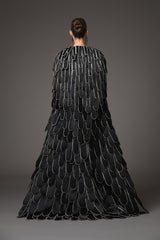 A cape with an overflow of layered hand-crafted plumes in scuba and crystals back view