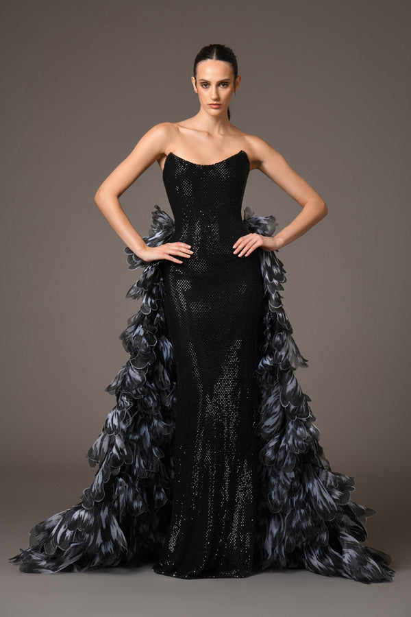 Corseted crystal embellished black gown with an overskirt of laser-cut organza flower petals