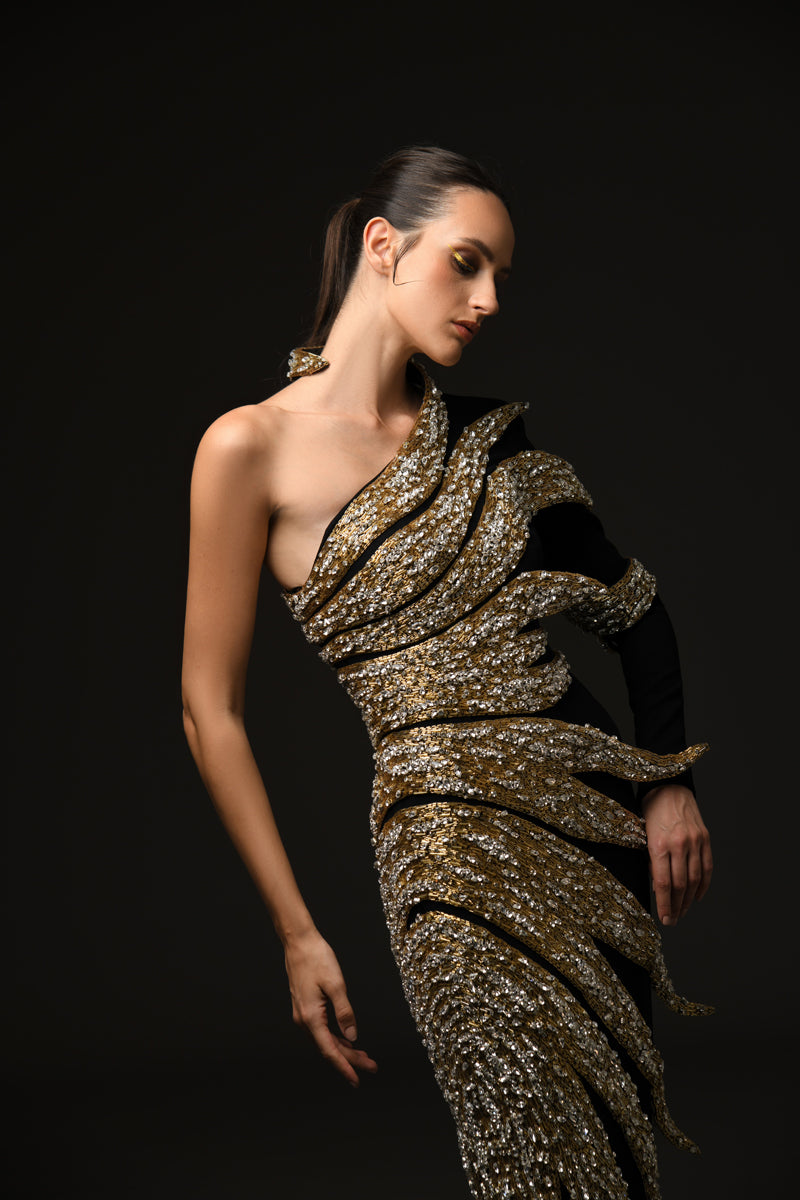 Black asymmetrical crepe dress with embroidered leaves in glass beads, bugle beads, and crystals close up