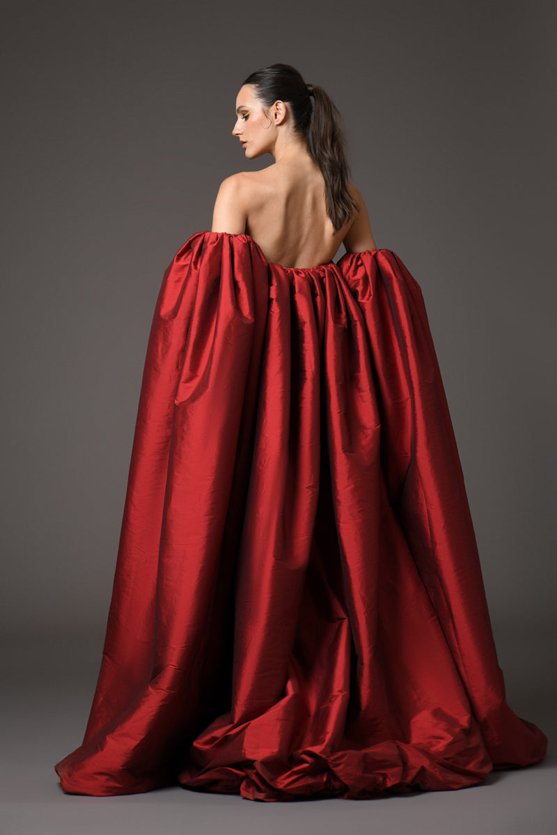 A red dress with intricate floral patterns embroidered with mirror plexiglass, with detachable taffeta sleeves/cape back