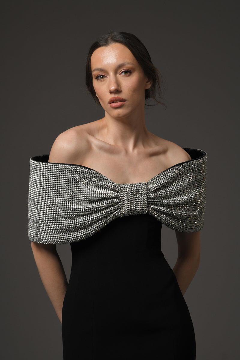 Black crêpe dress featuring a crystal bow