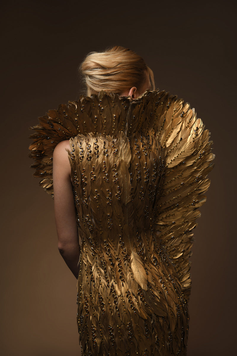 Golden feather beaded dress with a structured winged collar Golden feather beaded dress with a structured winged collar