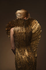 Golden feather gown with embroidery on feathers and a winged standing collar close up back