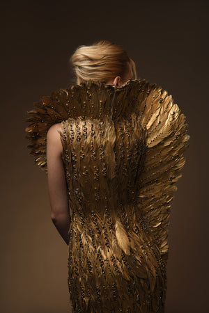 Golden feather gown with embroidery on feathers and a winged standing collar close up back