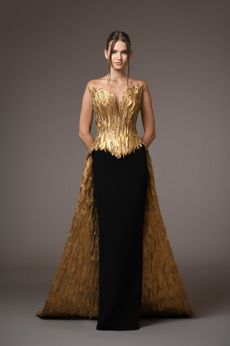 golden feather bustier with long overskirt with black crepe skirt