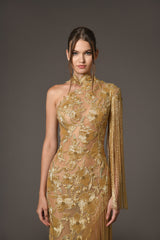 Assymetrical dress with floral patterns embroidered with gold beads close up